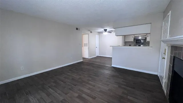 a view of a kitchen with a sink a dishwasher cabinets and wooden floor