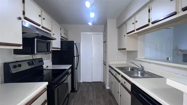 a kitchen with stainless steel appliances a sink stove and refrigerator