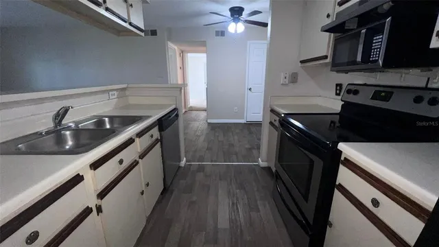 a kitchen that has a sink and a stove