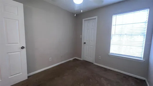 an empty room with a chandelier fan