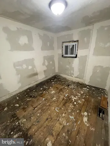 a room with gym equipment and a glass door shower