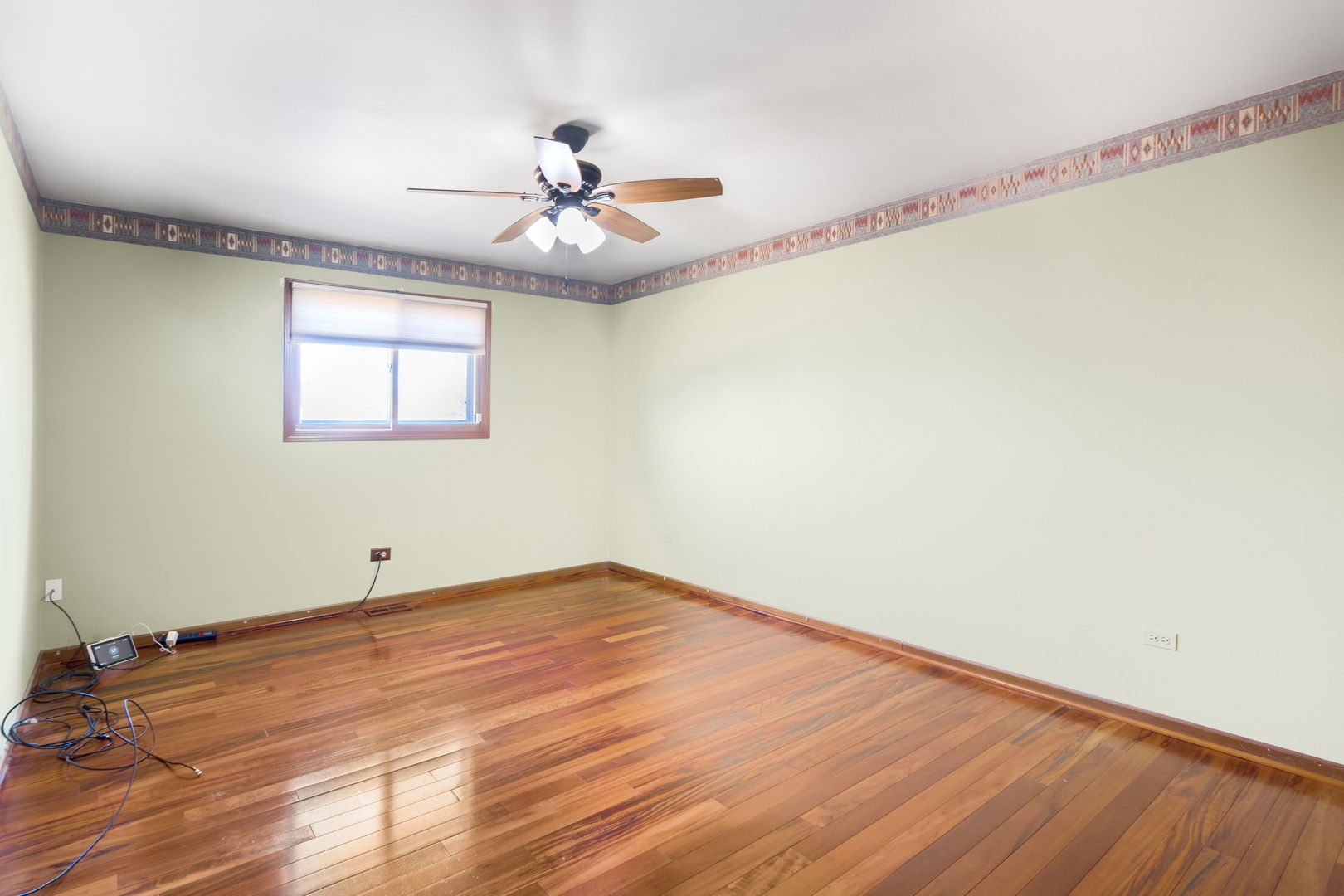 1200 Jacqueline Drive Crete, IL 60417 - Photo 13 of 21 a view of an empty room with wooden floor and a window
