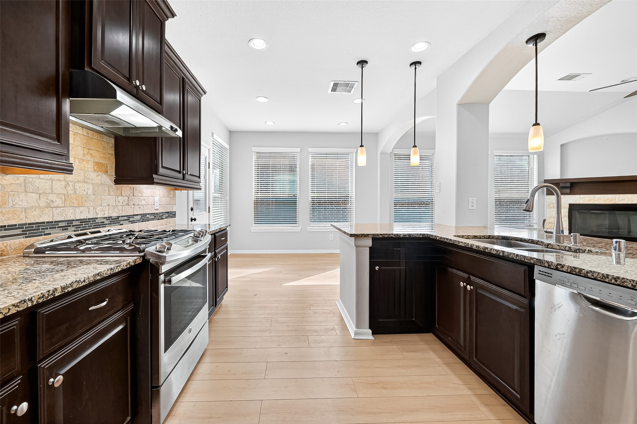 1531 Kent Valley Lane Rosenberg, TX 77471 - Photo 14 of 37 a kitchen with stainless steel appliances granite countertop a stove top oven a sink and dishwasher