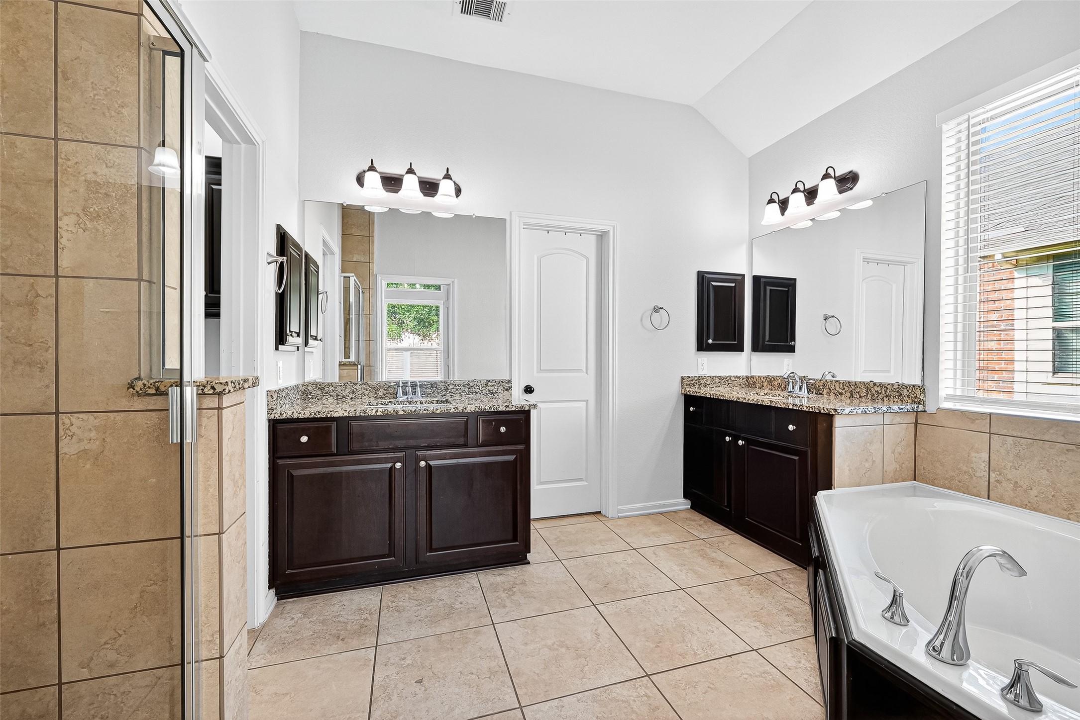 1531 Kent Valley Lane Rosenberg, TX 77471 - Photo 20 of 37 a spacious bathroom with a granite countertop tub sink and mirror
