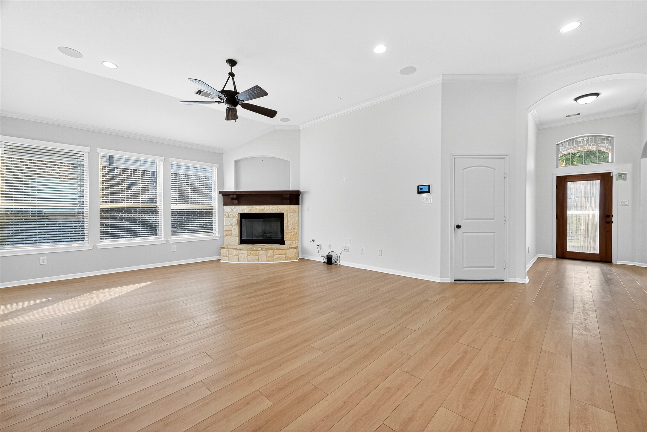 1531 Kent Valley Lane Rosenberg, TX 77471 - Photo 2 of 37 an empty room with wooden floor fireplace and windows