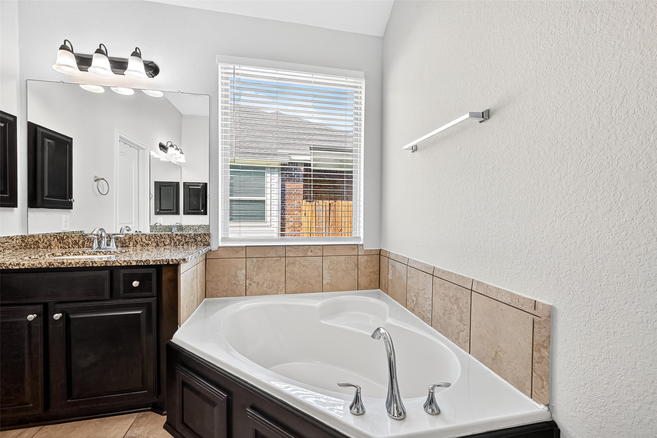 1531 Kent Valley Lane Rosenberg, TX 77471 - Photo 22 of 37 a bathroom with a granite countertop tub sink and mirror