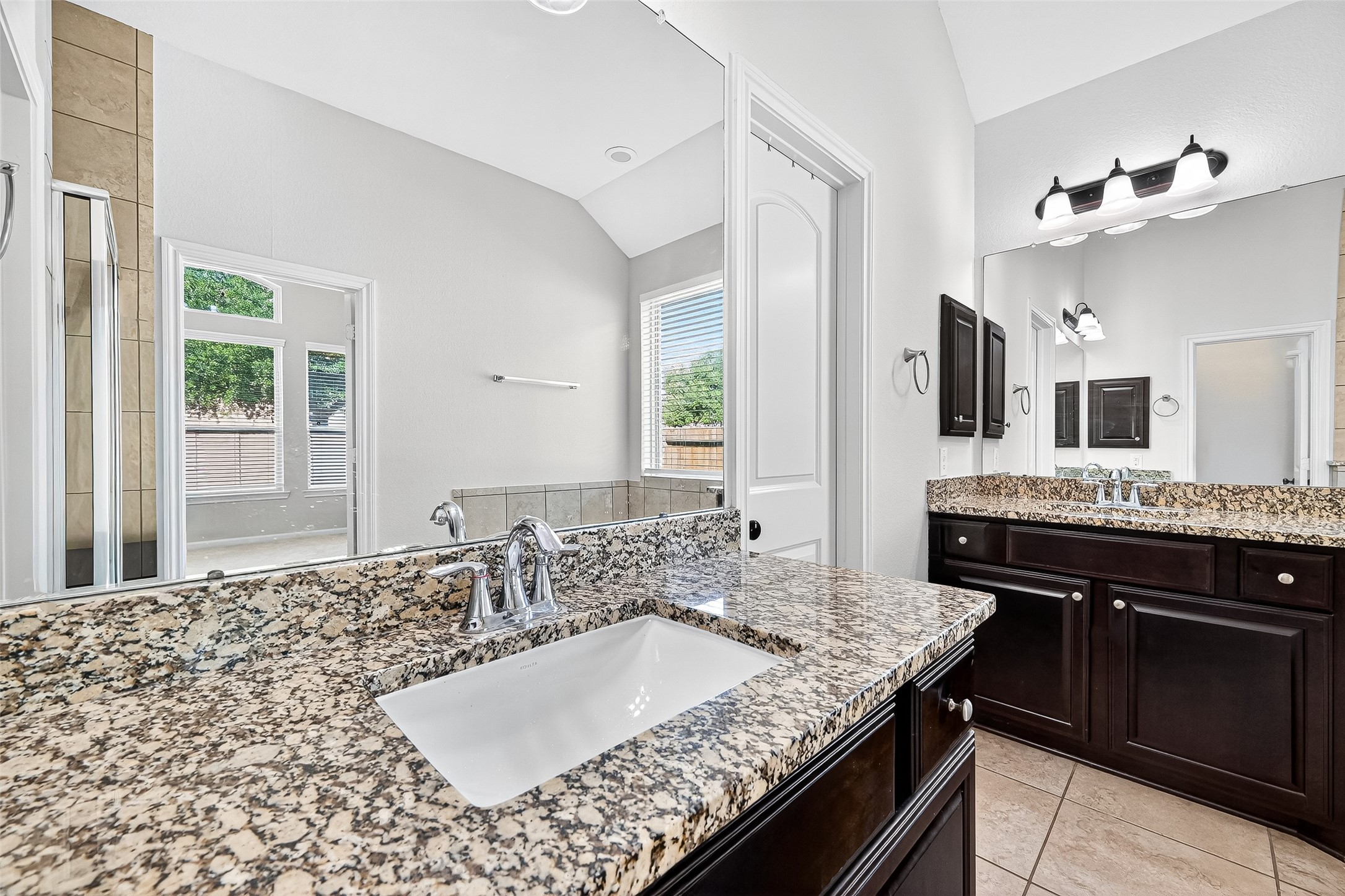1531 Kent Valley Lane Rosenberg, TX 77471 - Photo 23 of 37 a bathroom with a granite countertop sink a large mirror and a window