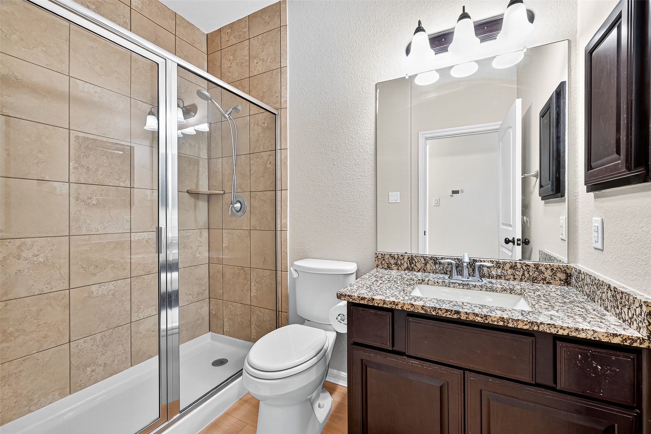 1531 Kent Valley Lane Rosenberg, TX 77471 - Photo 27 of 37 a bathroom with a granite countertop sink toilet and shower