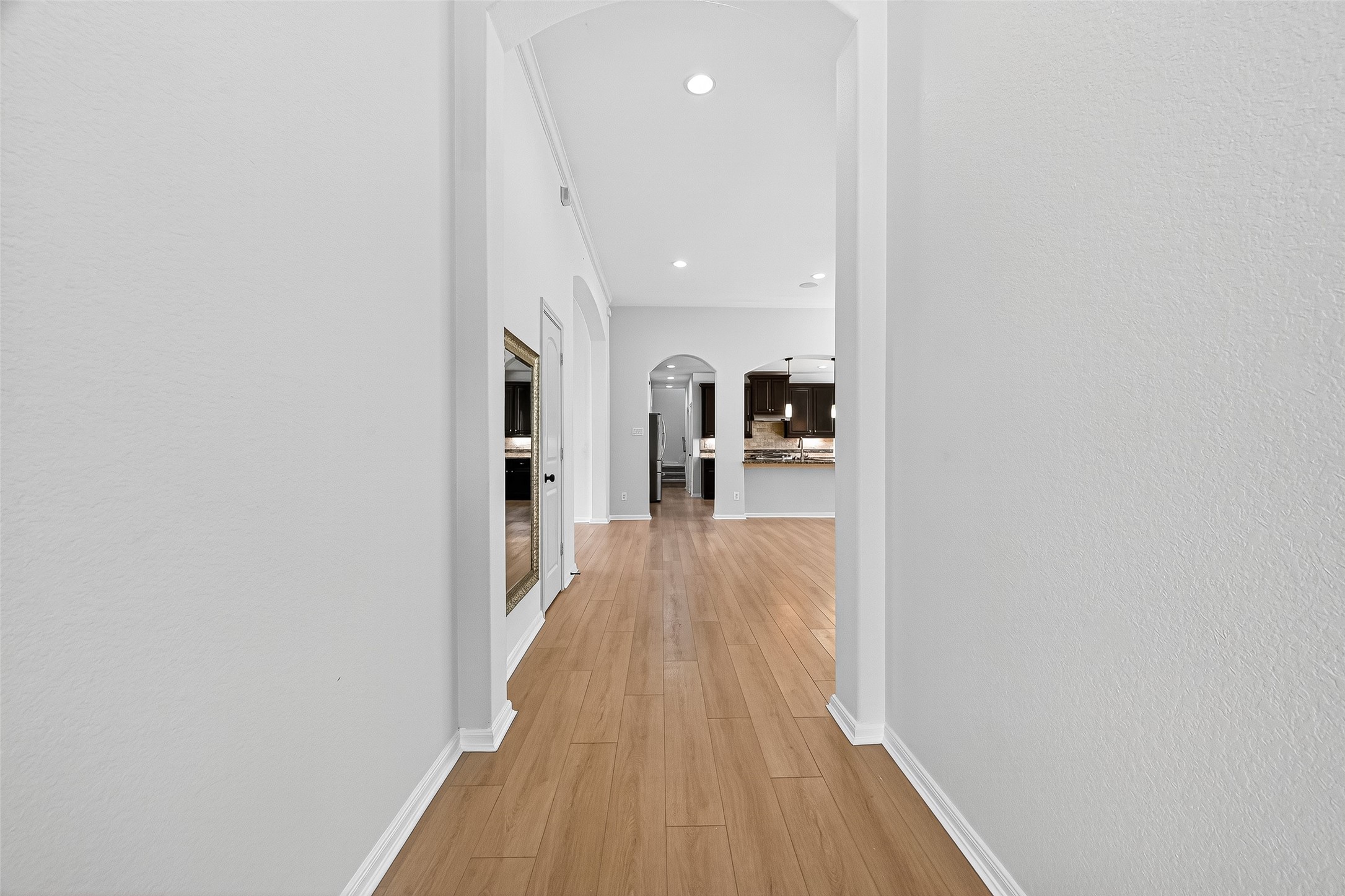 1531 Kent Valley Lane Rosenberg, TX 77471 - Photo 4 of 37 a view of a hallway with wooden floor and a bathroom