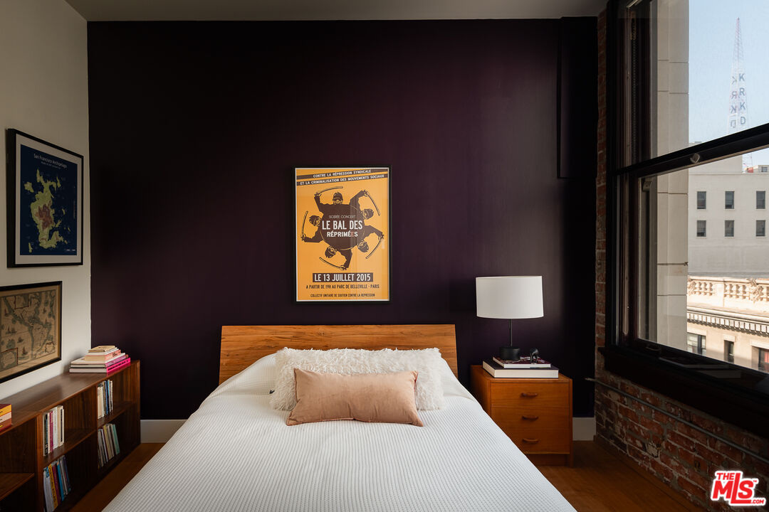 460 South Spring Street, Unit 1015 Los Angeles, CA 90013 - Photo 12 of 50 a bedroom with a bed and a lamp on dresser