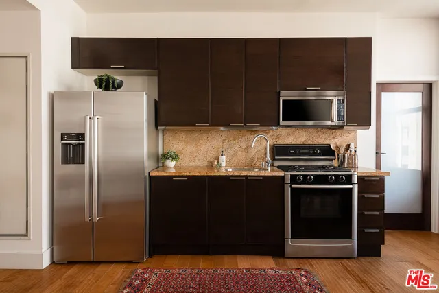 a kitchen with a refrigerator stove and microwave