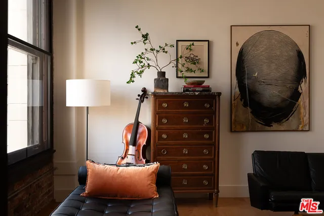 a view of a livingroom with furniture and a mirror
