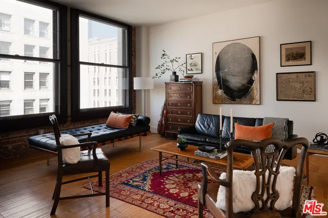 a living room with furniture and a floor to ceiling window