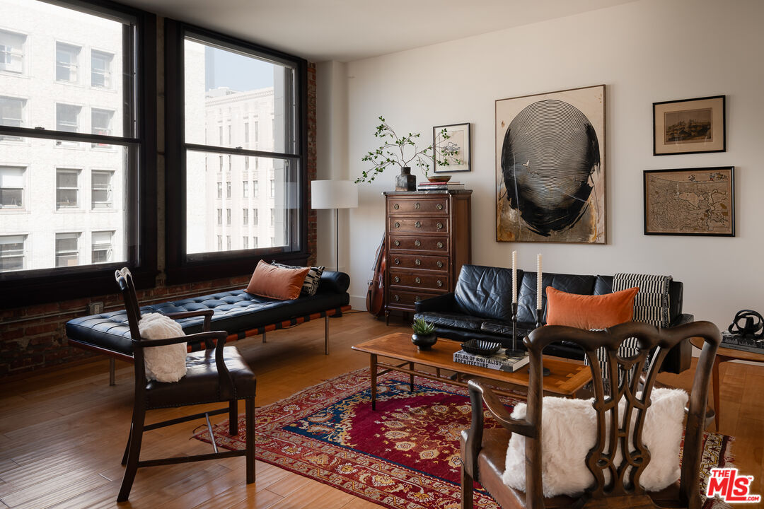 460 South Spring Street, Unit 1015 Los Angeles, CA 90013 - Photo 2 of 50 a living room with furniture and a floor to ceiling window