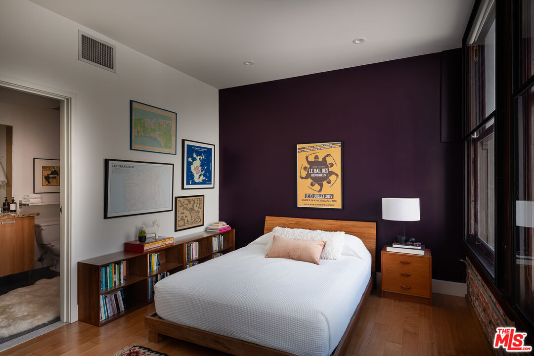 460 South Spring Street, Unit 1015 Los Angeles, CA 90013 - Photo 21 of 50 a bedroom with a bed and wooden floor
