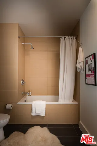 a bathroom with a bathtub and shower