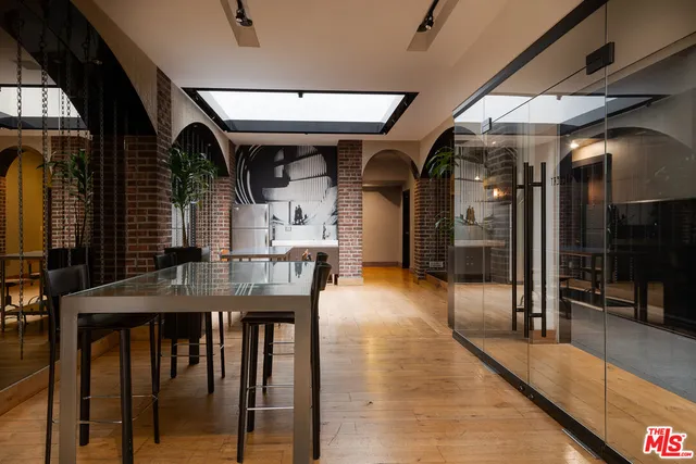 a living room with furniture and large windows