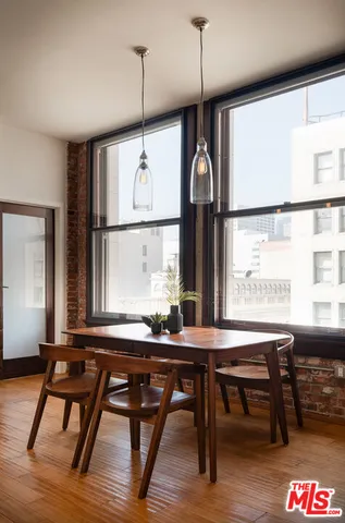 a room with a large window and wooden floor