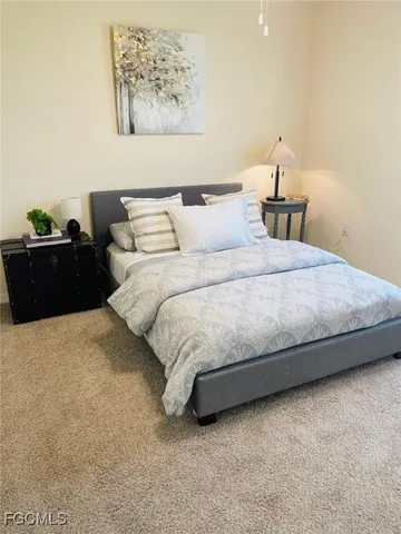 a bedroom with bed and a night stand