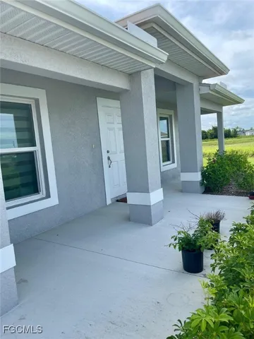 a view of a house with potted plants