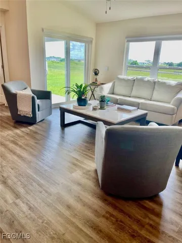a living room with furniture and a large window