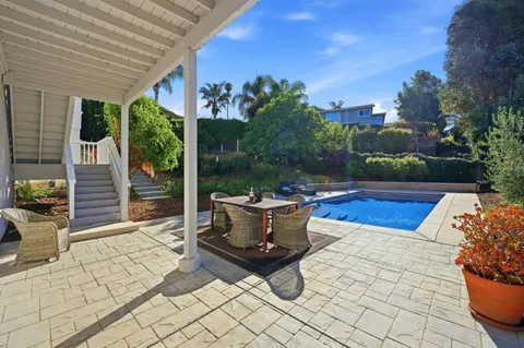 a view of swimming pool with outdoor seating and plants