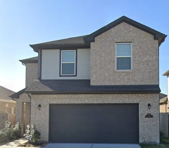 a front view of a house with a garage