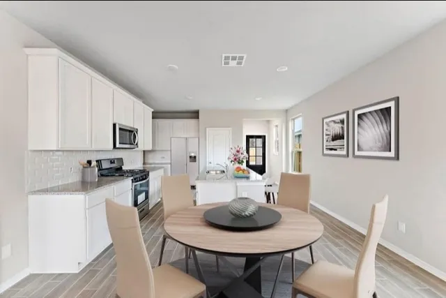a view of a dining room with furniture and wooden floor