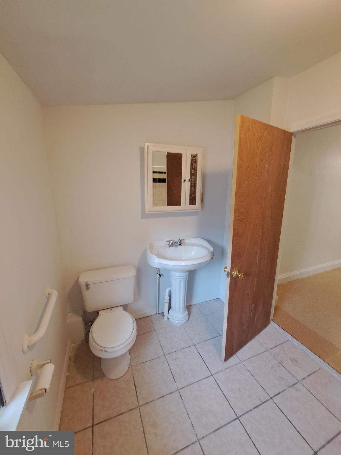 528 Hart Lane Philadelphia, PA 19134 - Photo 13 of 16 a bathroom with a toilet and a sink