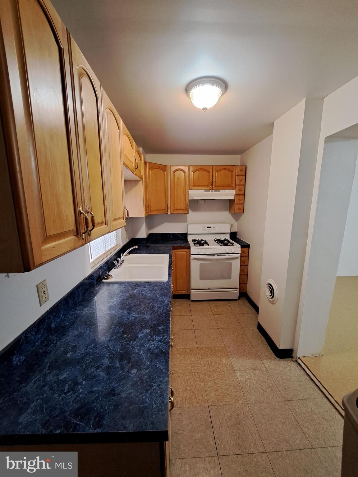 528 Hart Lane Philadelphia, PA 19134 - Photo 5 of 16 a kitchen with stainless steel appliances granite countertop a stove a sink and a microwave