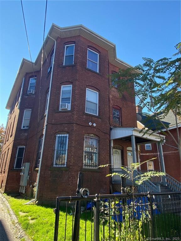 a front view of a building with garden