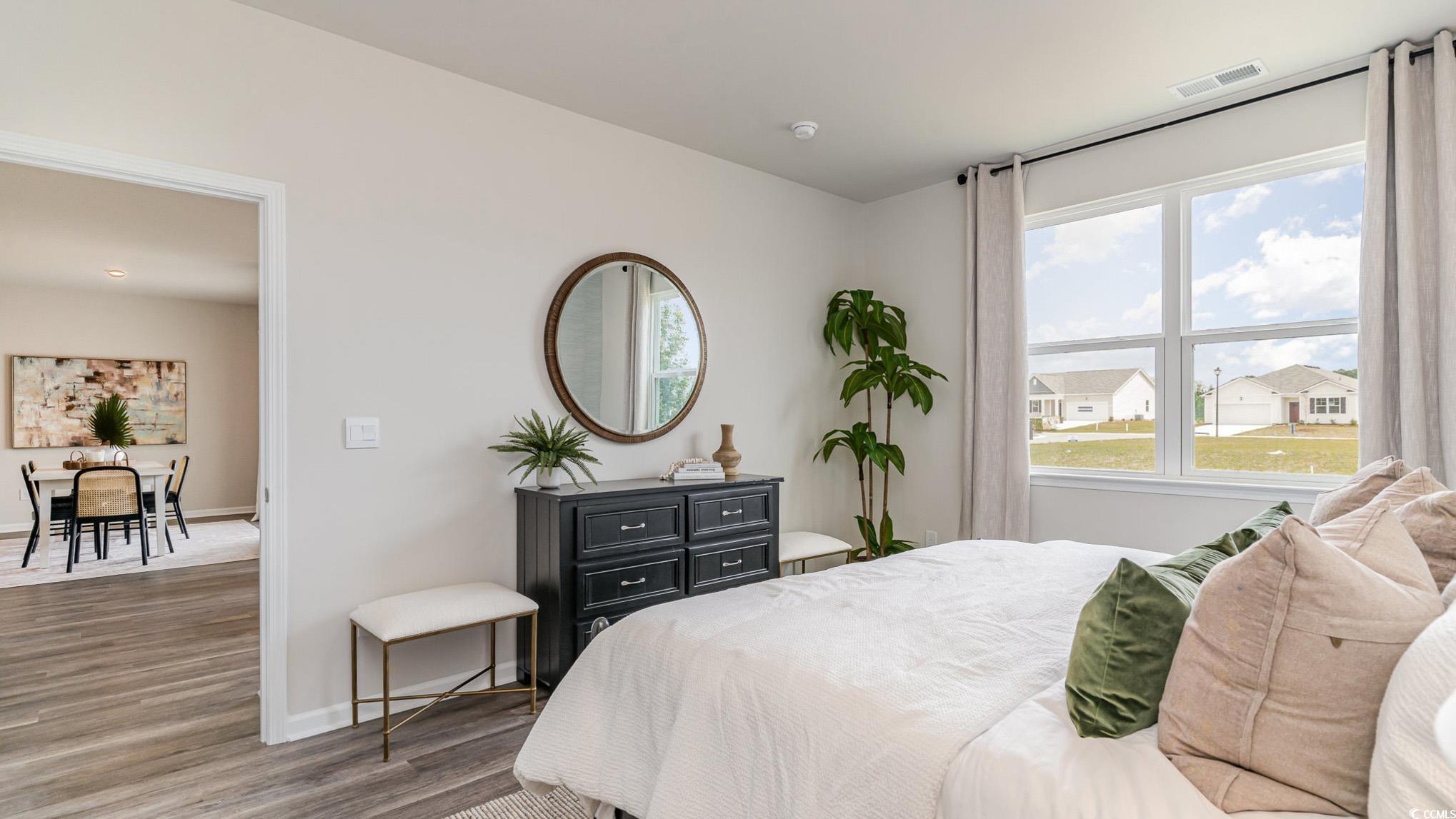 7447 Meadow Walk Loop Loris, SC 29569 - Photo 16 of 23 Bedroom featuring wood finished floors and multiple windows
