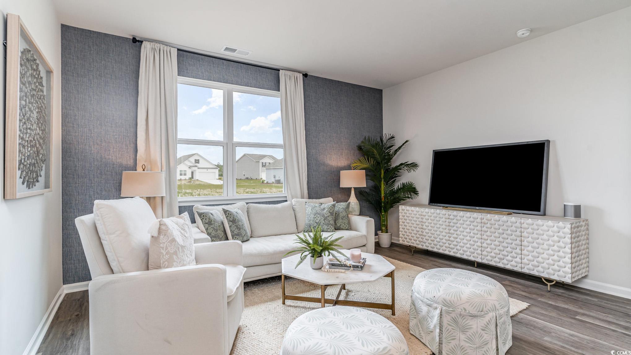 7447 Meadow Walk Loop Loris, SC 29569 - Photo 5 of 23 Living room with wood finished floors and baseboards