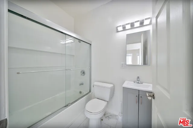 a bathroom with a toilet a sink and shower