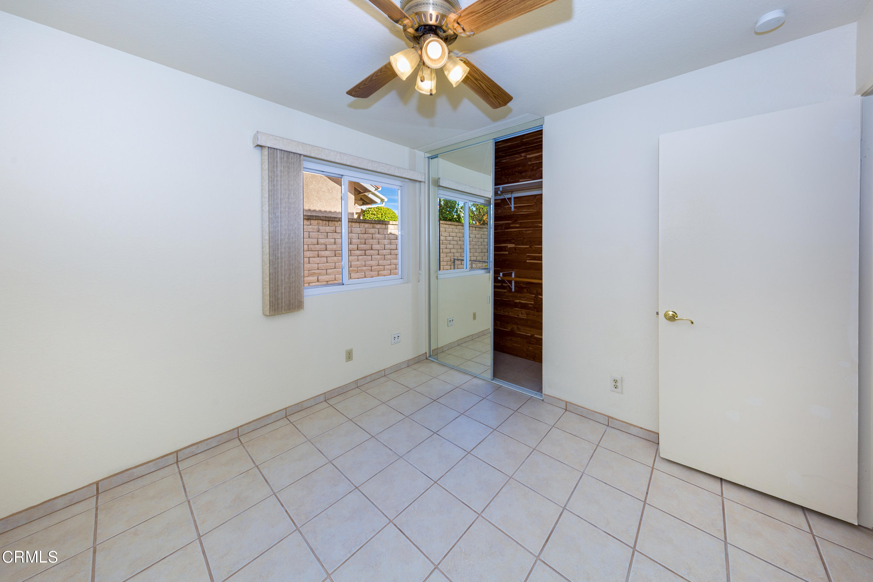 6025 Palomar Circle Camarillo, CA 93012 - Photo 16 of 35 an empty room with chandelier fan and windows