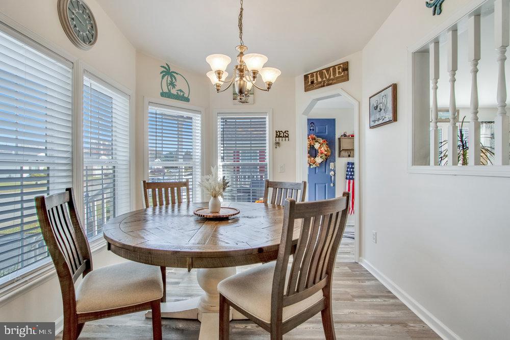 1125 Lorenzo Lane, Unit 274 Smyrna, DE 19977 - Photo 10 of 43 a view of a dining room with furniture window and wooden floor