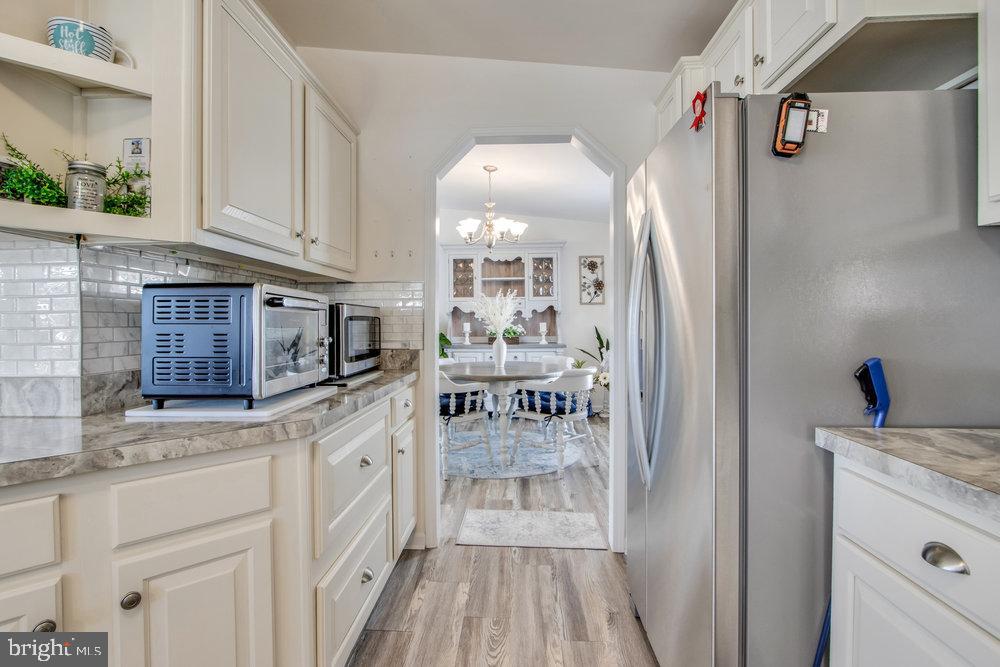 1125 Lorenzo Lane, Unit 274 Smyrna, DE 19977 - Photo 14 of 43 a kitchen with white cabinets and refrigerator
