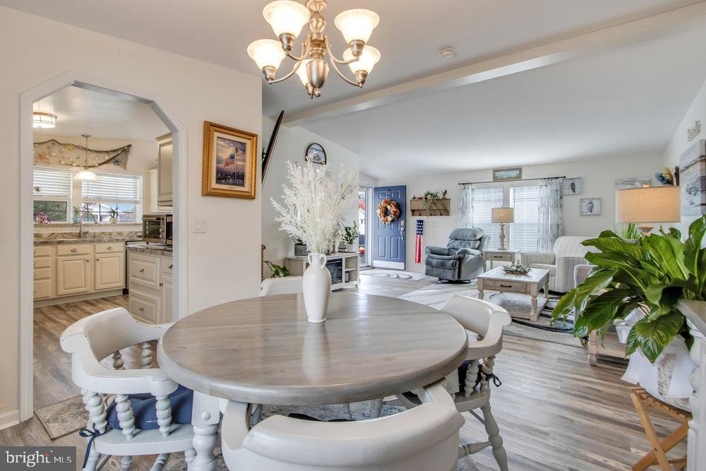 1125 Lorenzo Lane, Unit 274 Smyrna, DE 19977 - Photo 17 of 43 a view of a dining room with furniture and wooden floor