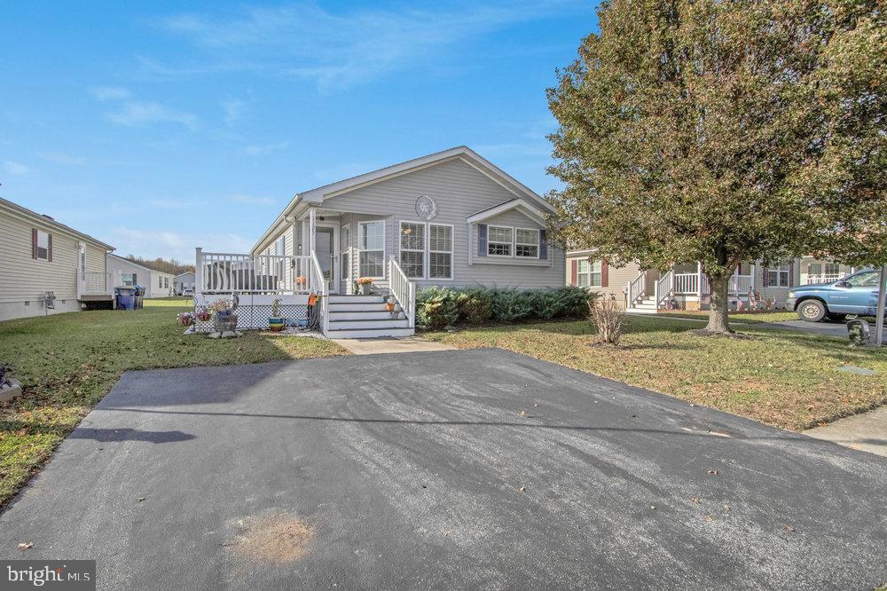 1125 Lorenzo Lane, Unit 274 Smyrna, DE 19977 - Photo 2 of 43 a front view of a house with a yard and garage