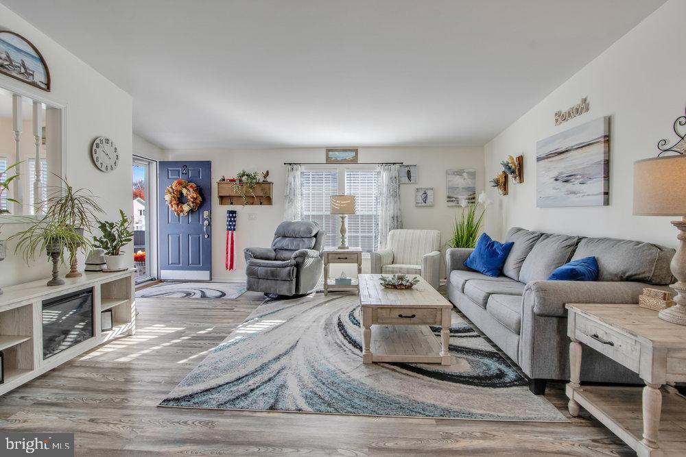 1125 Lorenzo Lane, Unit 274 Smyrna, DE 19977 - Photo 20 of 43 a living room with furniture and a wooden floor