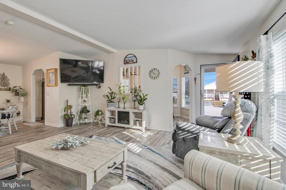 1125 Lorenzo Lane, Unit 274 Smyrna, DE 19977 - Photo 22 of 43 a living room with furniture a flat screen tv and a table