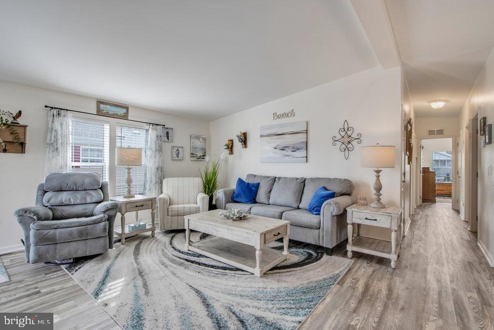 1125 Lorenzo Lane, Unit 274 Smyrna, DE 19977 - Photo 23 of 43 a living room with furniture and a wooden floor
