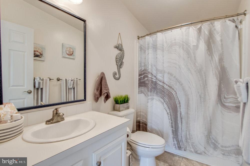 1125 Lorenzo Lane, Unit 274 Smyrna, DE 19977 - Photo 26 of 43 a bathroom with a sink a toilet and a mirror