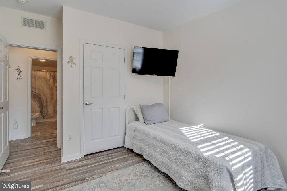 1125 Lorenzo Lane, Unit 274 Smyrna, DE 19977 - Photo 28 of 43 a bedroom with a bed and a flat screen tv