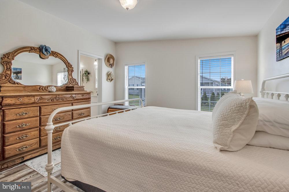 1125 Lorenzo Lane, Unit 274 Smyrna, DE 19977 - Photo 31 of 43 a bedroom with a bed and dresser with mirror