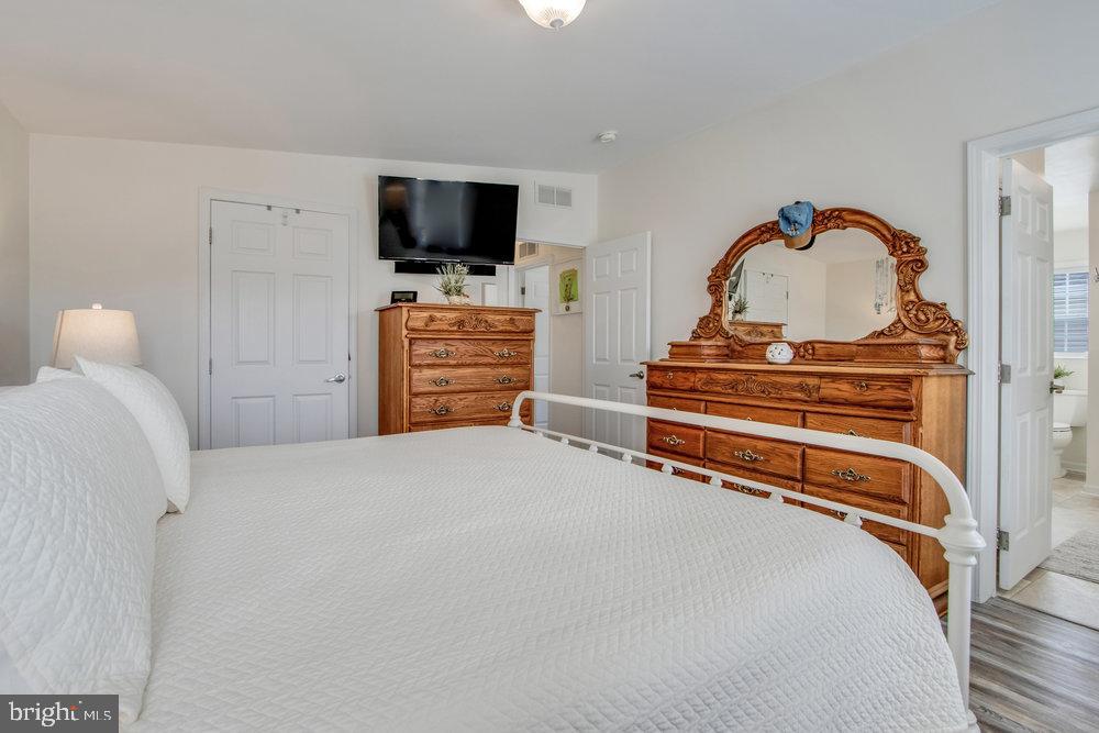 1125 Lorenzo Lane, Unit 274 Smyrna, DE 19977 - Photo 33 of 43 a bedroom with a bed and a flat screen tv