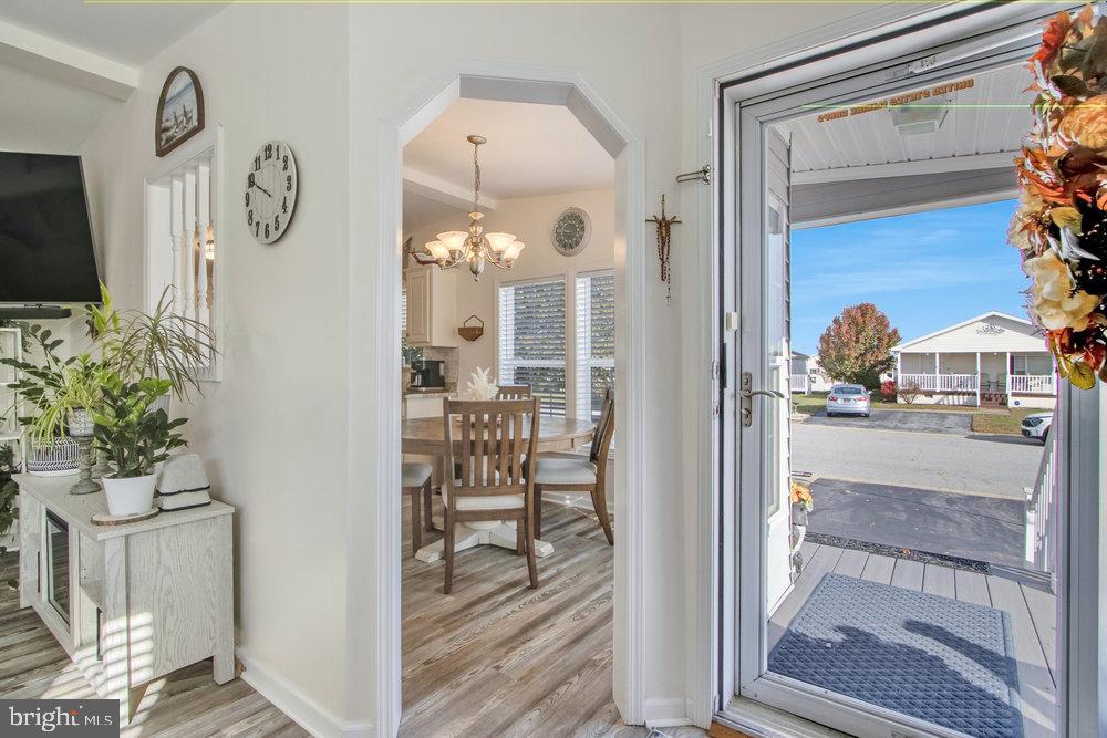 1125 Lorenzo Lane, Unit 274 Smyrna, DE 19977 - Photo 7 of 43 a view of a hallway with wooden floor and a living room