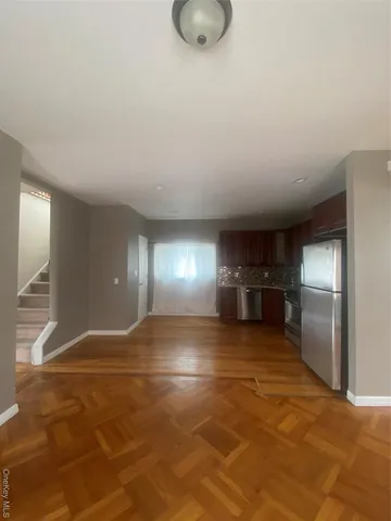 a view of a room window and wooden floor