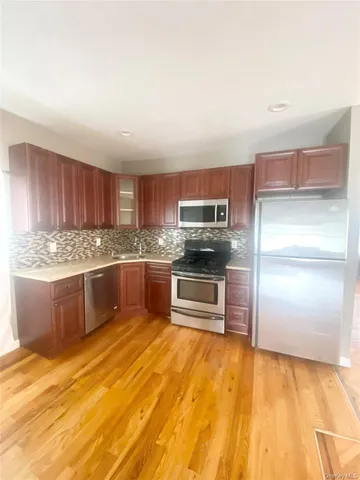 a kitchen with stainless steel appliances a refrigerator and a stove top oven