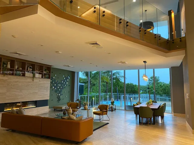 a living room with furniture and large windows